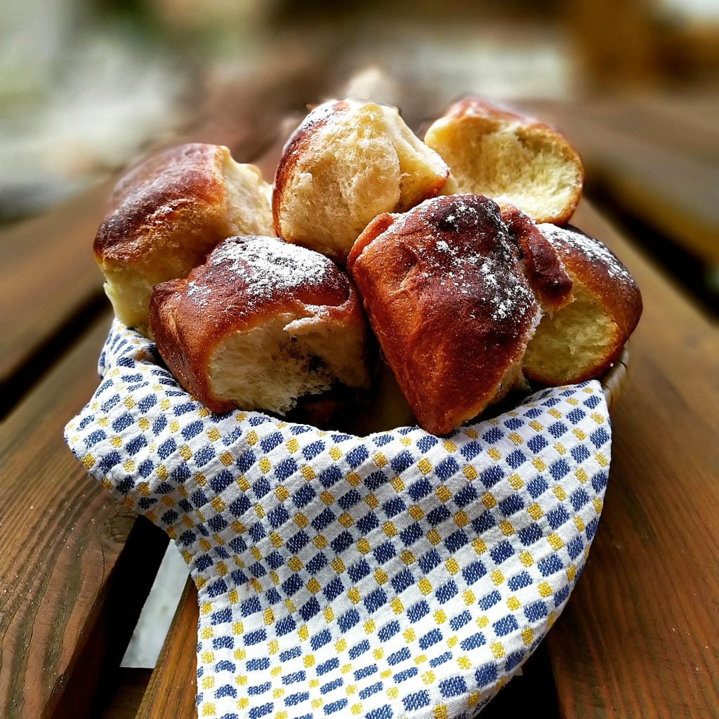 Košík s čerstvě upečenými domácími Honzovými buchtami sypanými cukrem v kavárně V Klenbách.